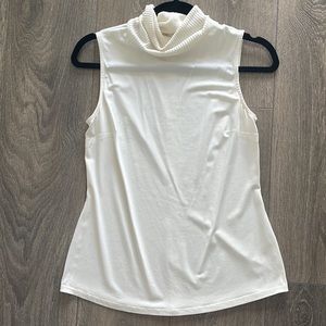 White sleeveless turtleneck blouse